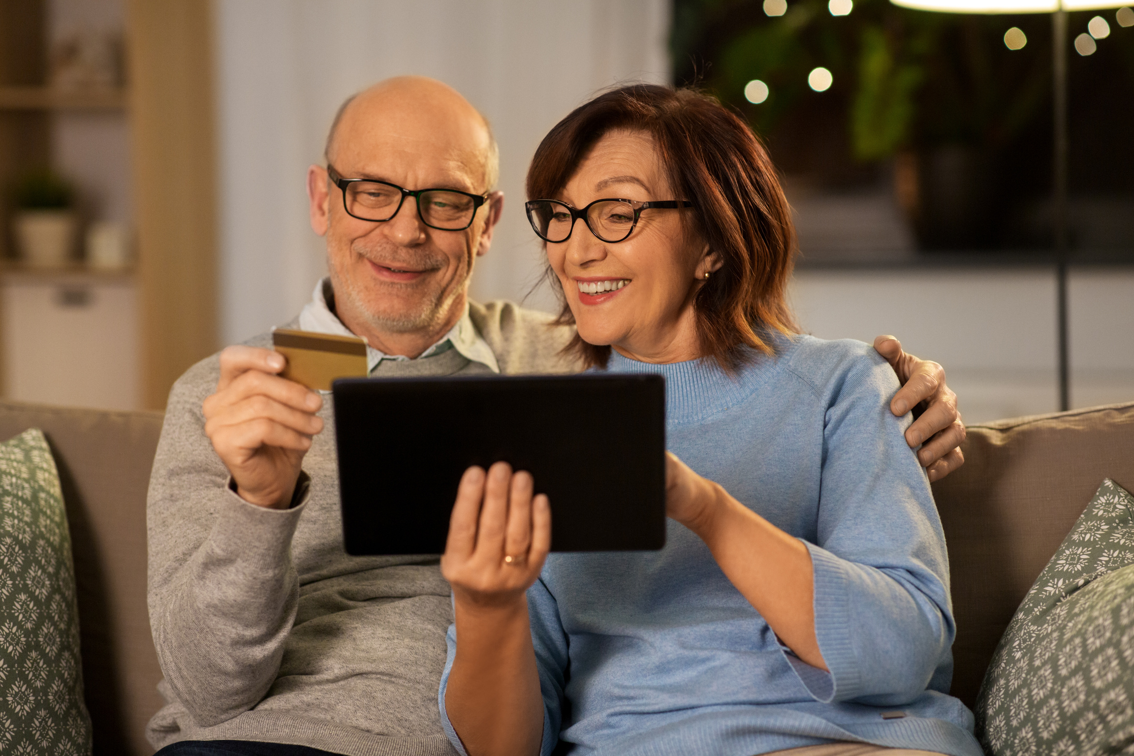 Happy Senior Couple with Tablet and Credit Card